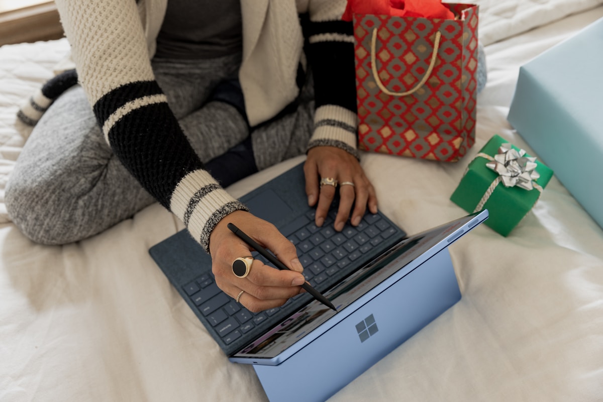 Laptop displaying online purchase of a Windows product key with a security shield icon representing safe buying